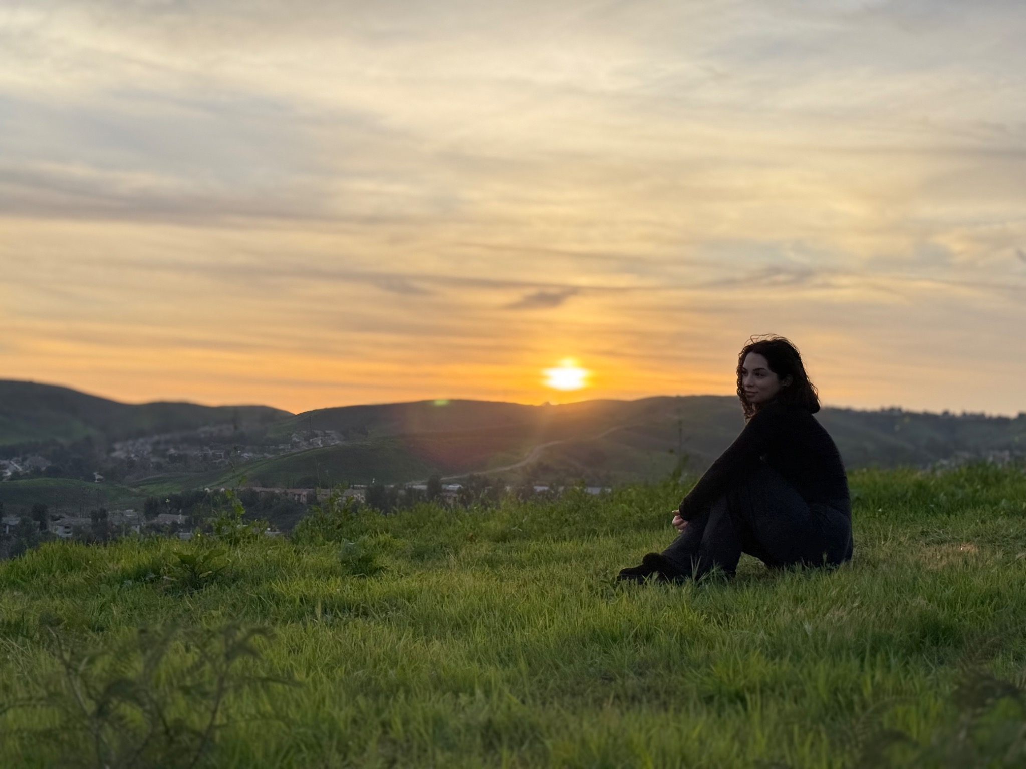 Mari sitting outdoors during sunset
