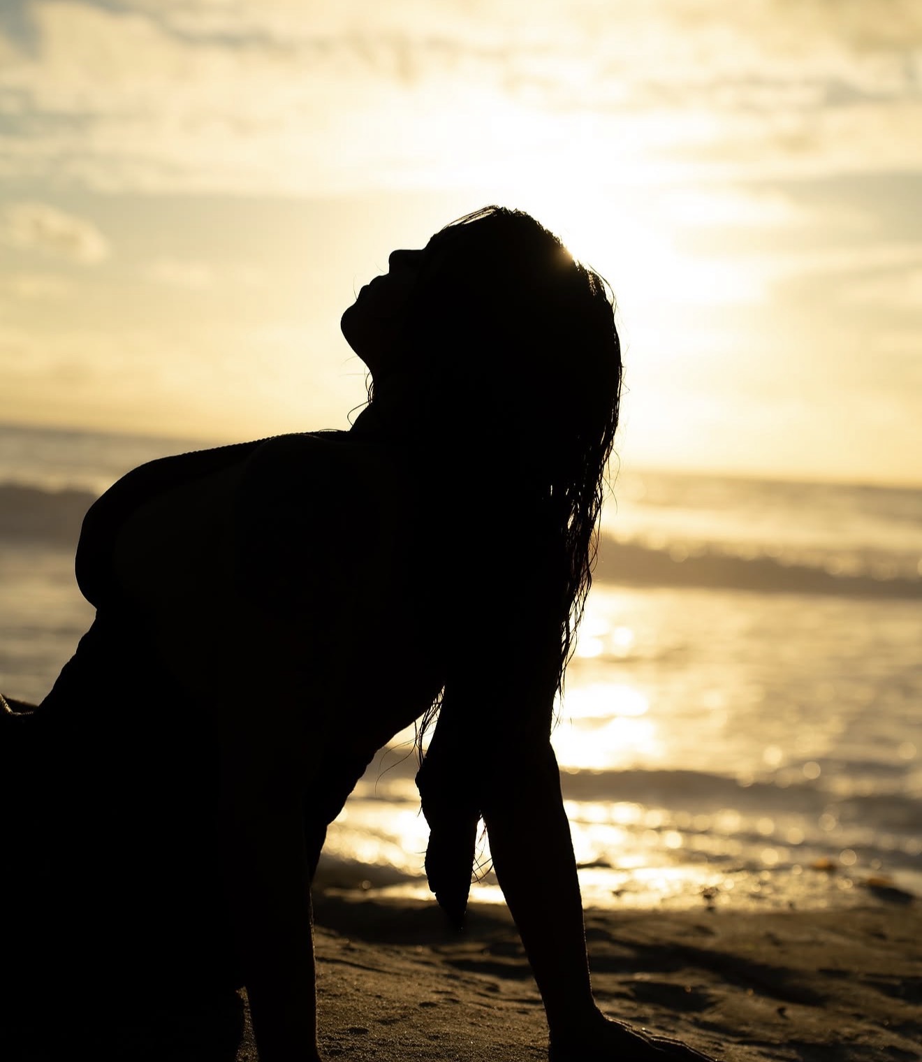 Silhouette portrait photographed at the beach during sunset